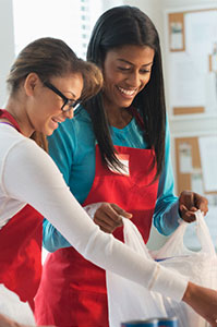 A smiling female doctor consults with a happy couple, fostering a positive and professional healthcare experience.